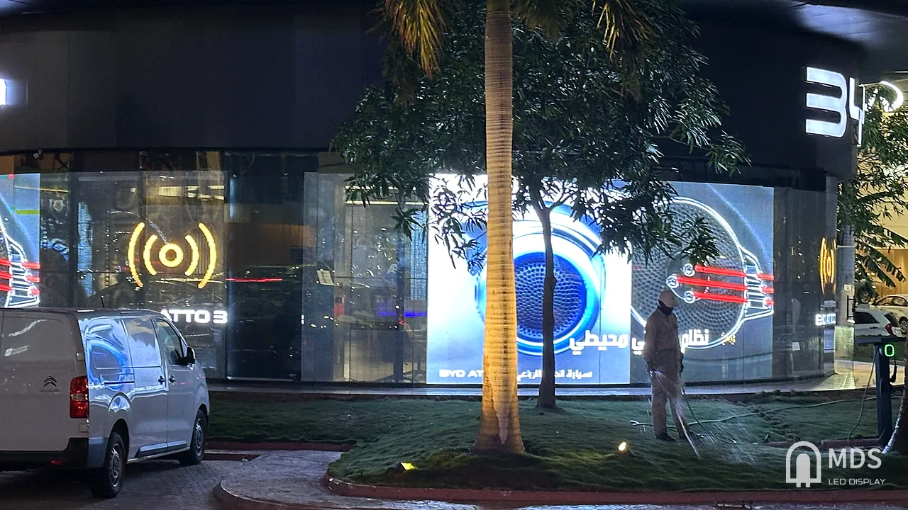 BYD showroom in Jeddah: transparent LED on the glass facade playing an ATTO 3 feature animation