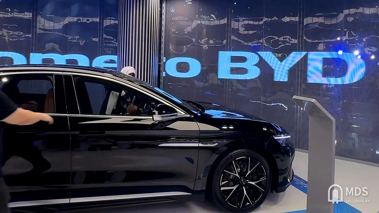 Inside the BYD Jeddah showroom: the inner face of the double-sided transparent LED shows 'Welcome to BYD' to visitors