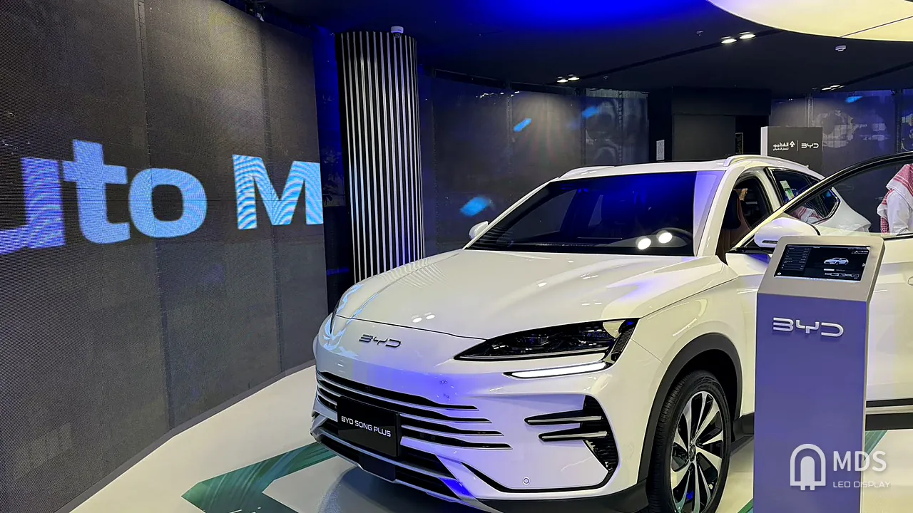 Inside the BYD Jeddah showroom: display car in front of the transparent LED wall