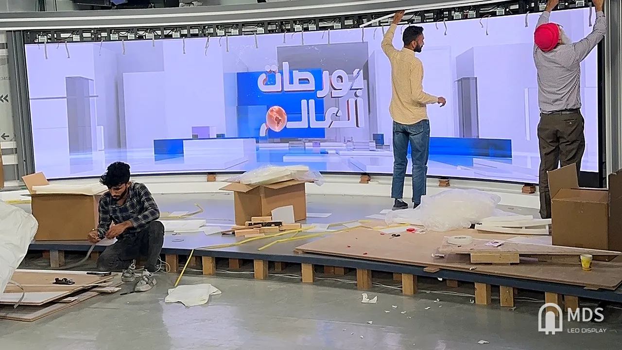 Installation in progress: MDS technicians fitting the curved LED wall in the CNBC Arabia studio